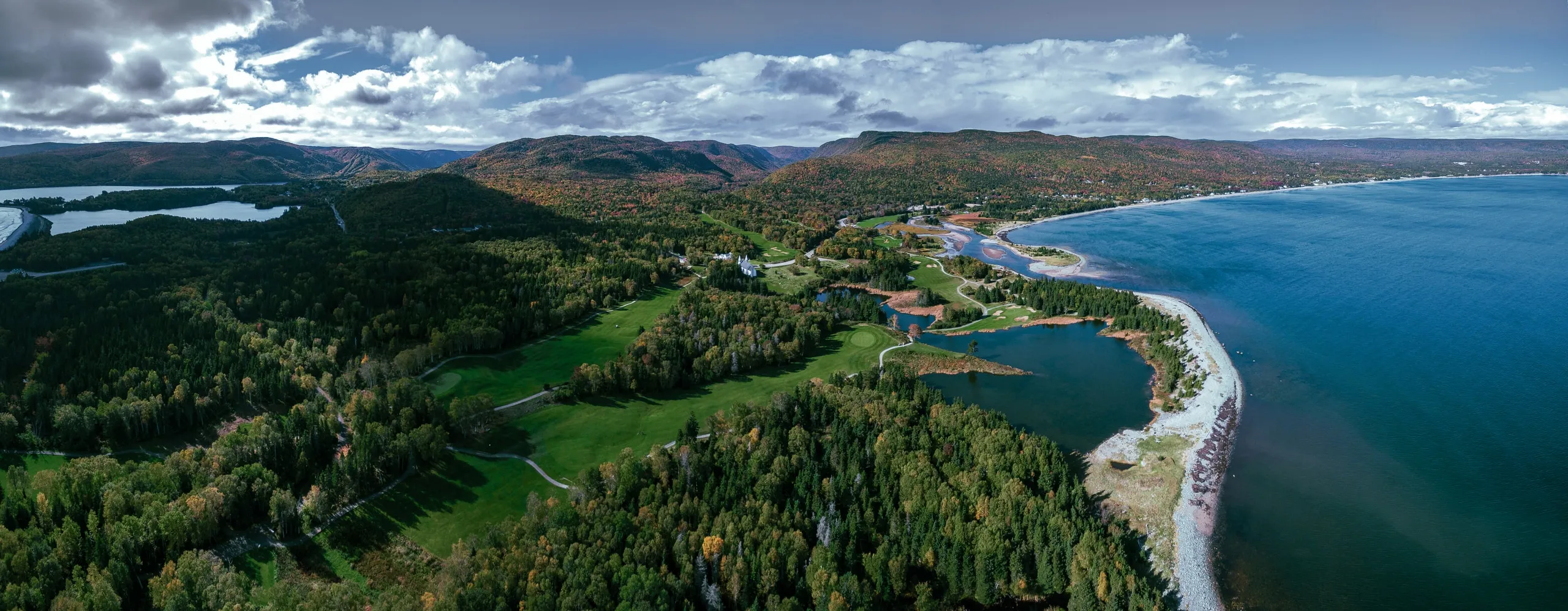 Aerial view of Cape Breton Highlands Links, with fairways between forested hills and the Atlantic coast