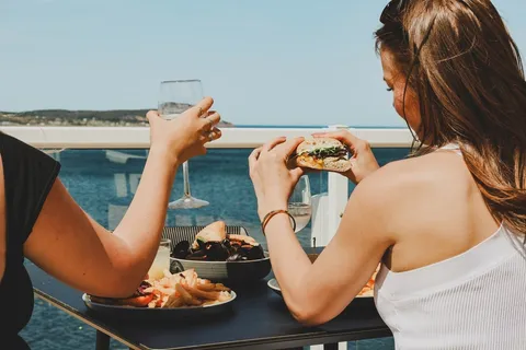 Guests dining on a deck overlooking the Atlantic.