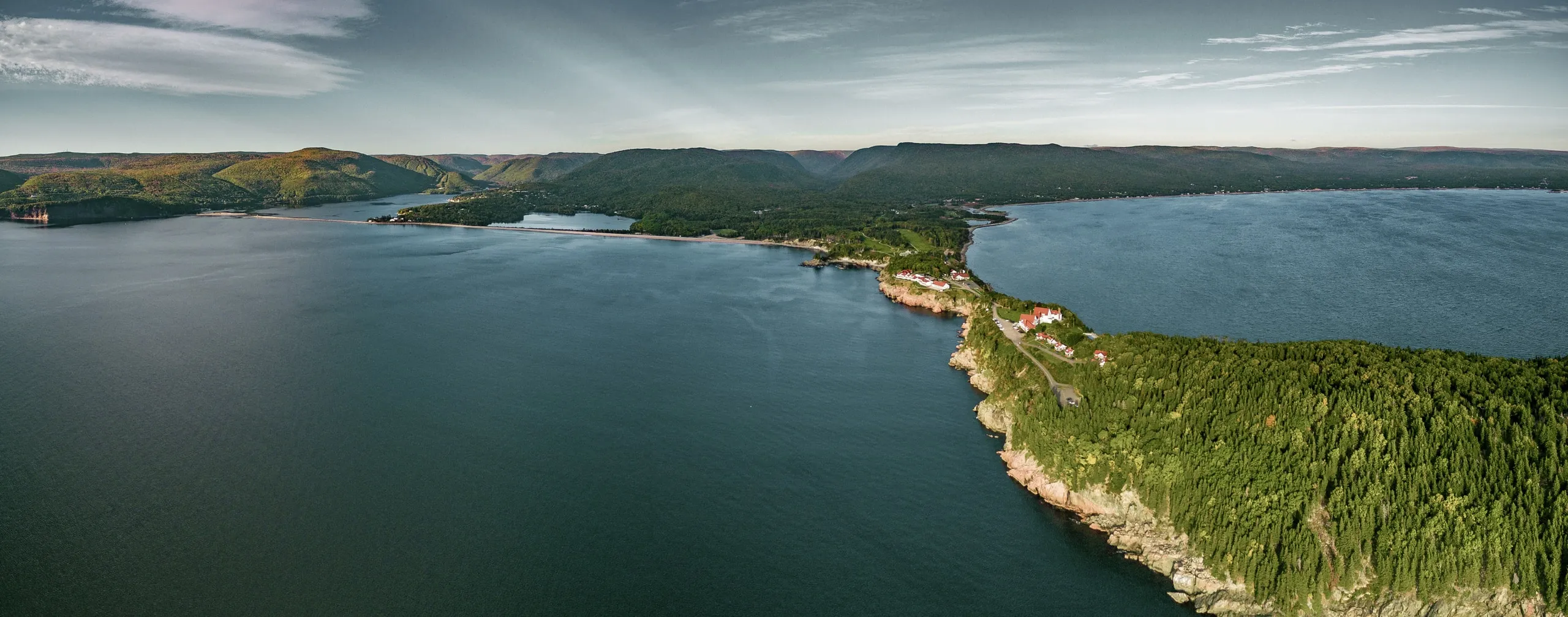 Aerial view of a forested peninsula stretching into the Atlantic.